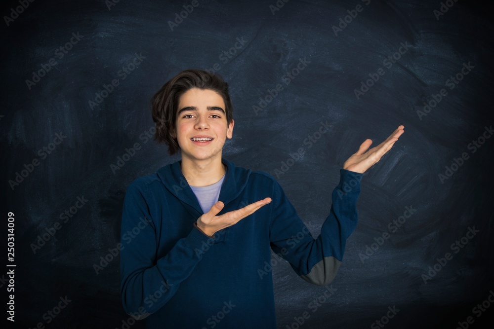 portrait of smiling teenager pointing portrait of smiling teenager pointing