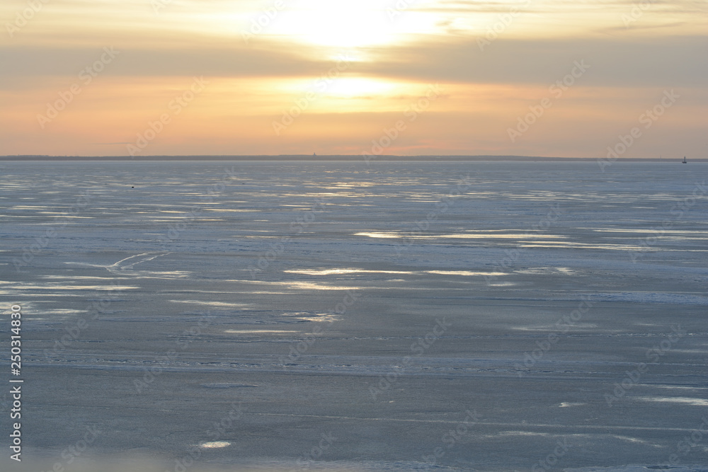 sunset over the frozen Gulf of Finland