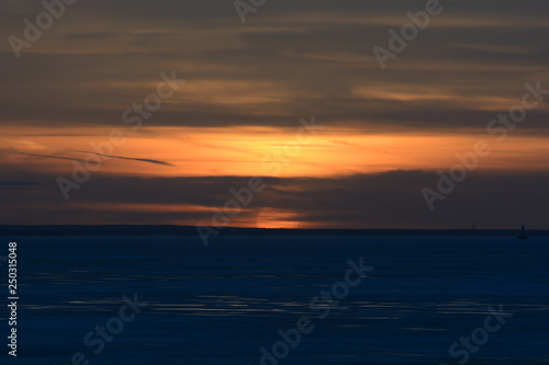 sunset over the frozen Gulf of Finland © Алексей Кононов