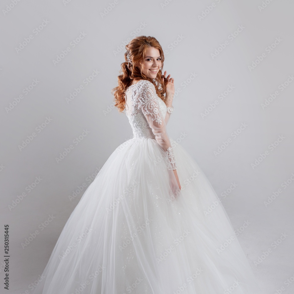 Happy young woman bride in a lavish wedding dress. Happy young woman bride in a lavish wedding dress.
