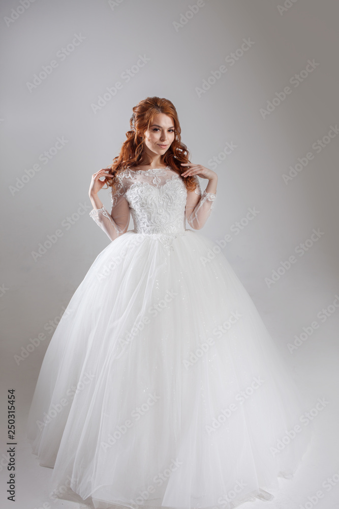 Happy young woman bride in a lavish wedding dress. Happy young woman bride in a lavish wedding dress.