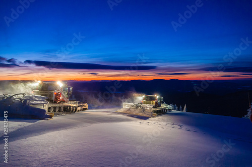 Fotografija Snowcat grooming trails in the early morning.