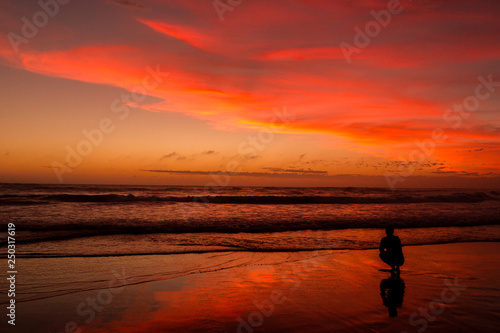 Young man sitting outdoors watching the sunset. Thinking and relaxing concept, Australia © Martin