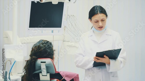 The doctor records the patient's data or the history of the disease. Visit a doctor or dentist to your office. White is even. Medical and pharmacy concepts.