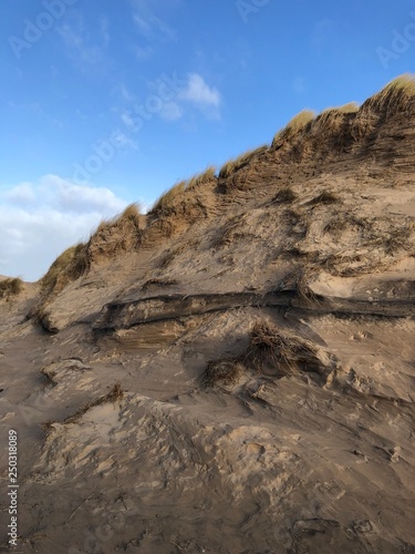 Grassy, Sandy Hills against Blue Sky