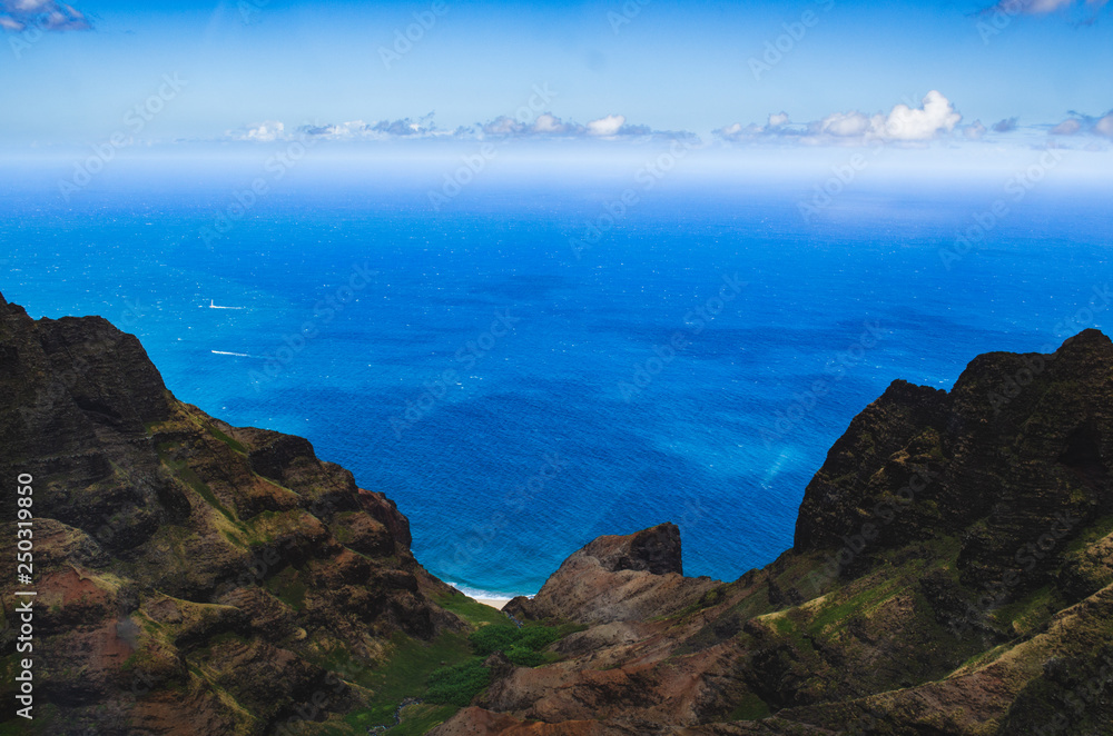 Fototapeta premium Aerial view of the abrupt and green Napali Coast in Kauai, US