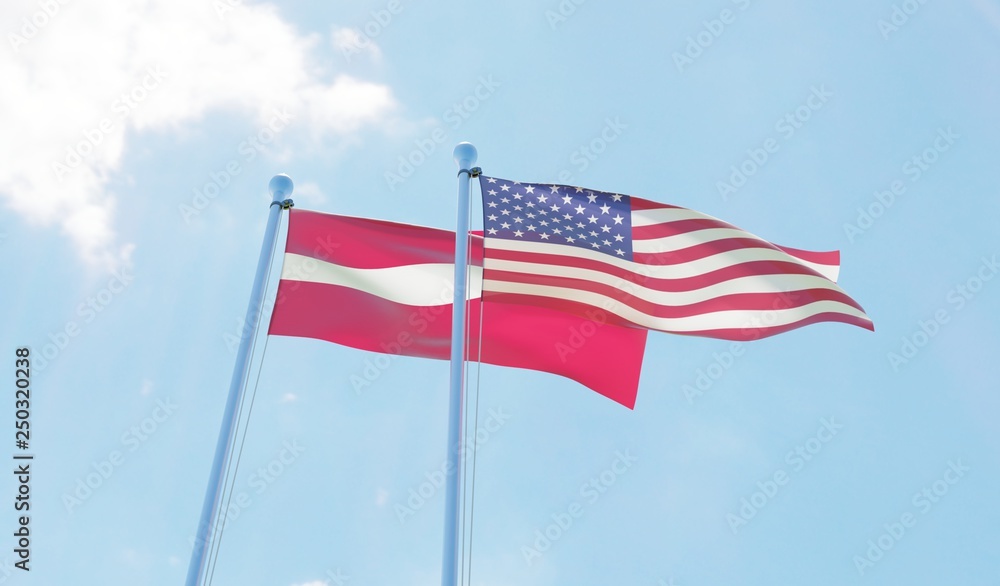 Latvia and USA, two flags waving against blue sky. 3d image