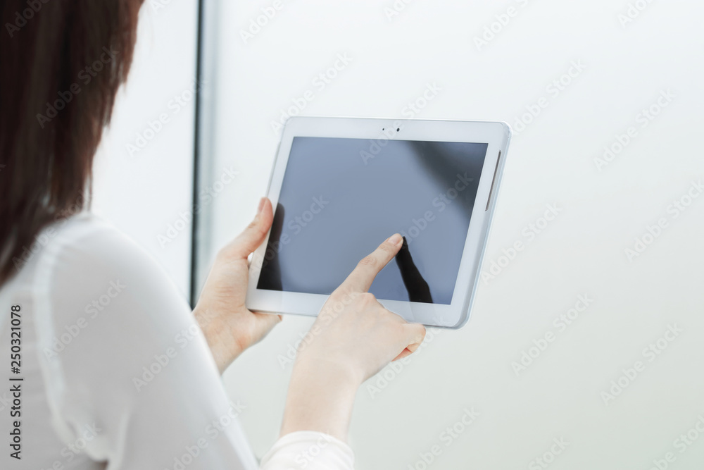 close up.businesswoman clicking on the screen of the digital tablet