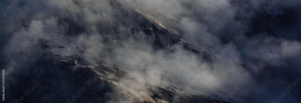 view of a valley in a beautiful early morning with fog between hills