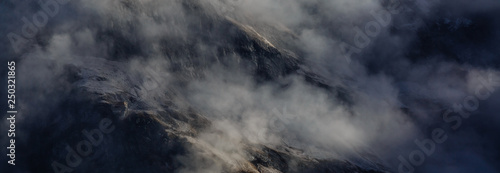 view of a valley in a beautiful early morning with fog between hills