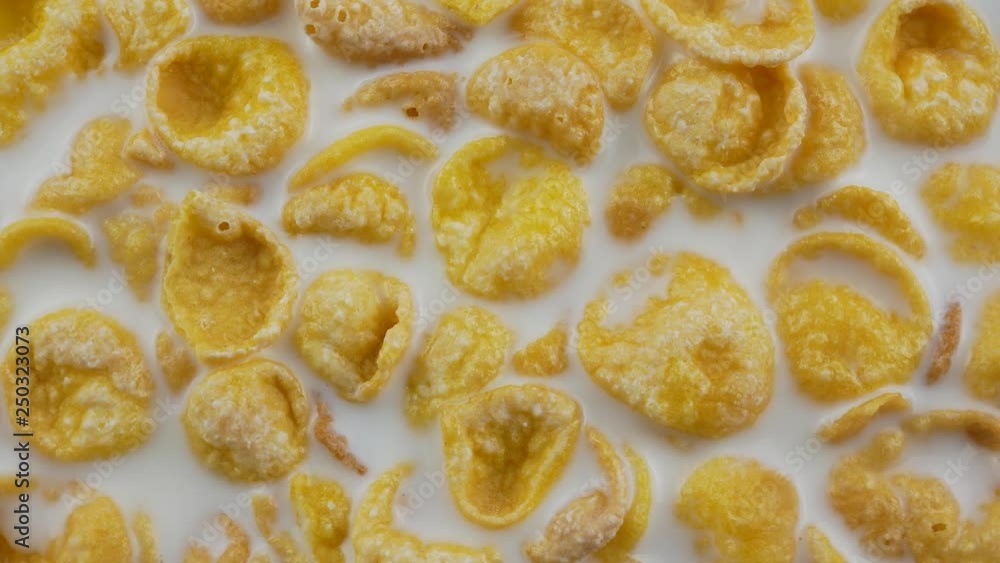 Cornflakes cereal and milk in a clay bowl. Morning breakfast. Cornflakes cereal and milk in a clay bowl. Morning breakfast.