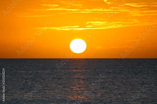 Fototapeta Naklejka Na Ścianę i Meble -  Clouds and sun at sunset on the sea. Long Island, Bahamas