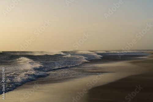Beautiful spanish coastline  Beach  Sea  Waves with white crest during sunset