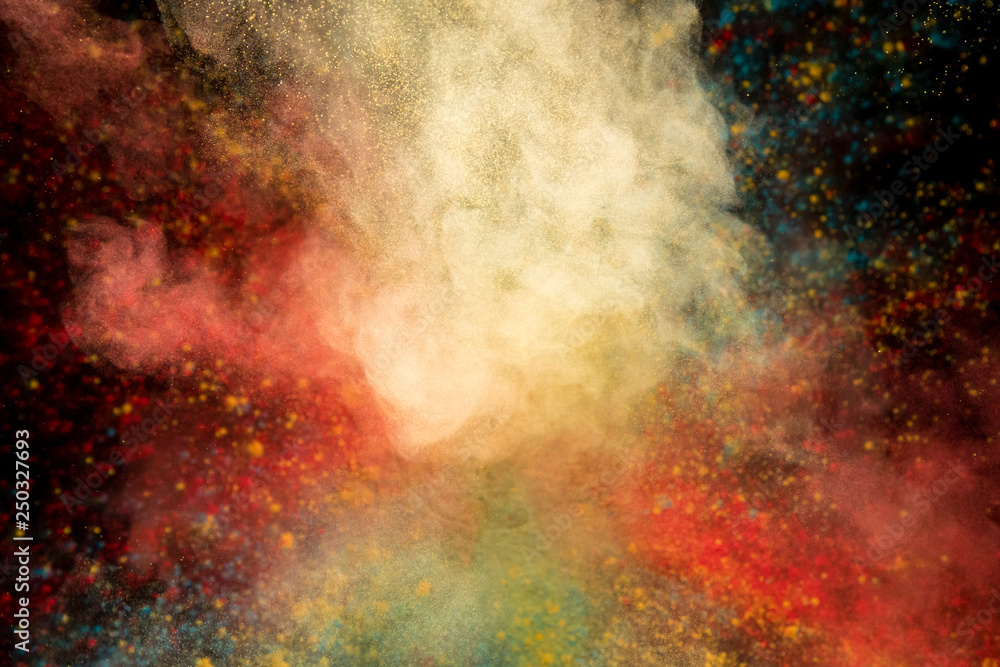 Colored powder explosion on black background. Freeze motion.