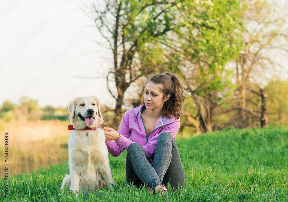 Portrait of young beautiful woman sitting and hugging her golden retriever dog. Happiness and friendship. pet and woman. Portrait of young beautiful woman sitting and hugging her golden retriever dog. Happiness and friendship. pet and woman.