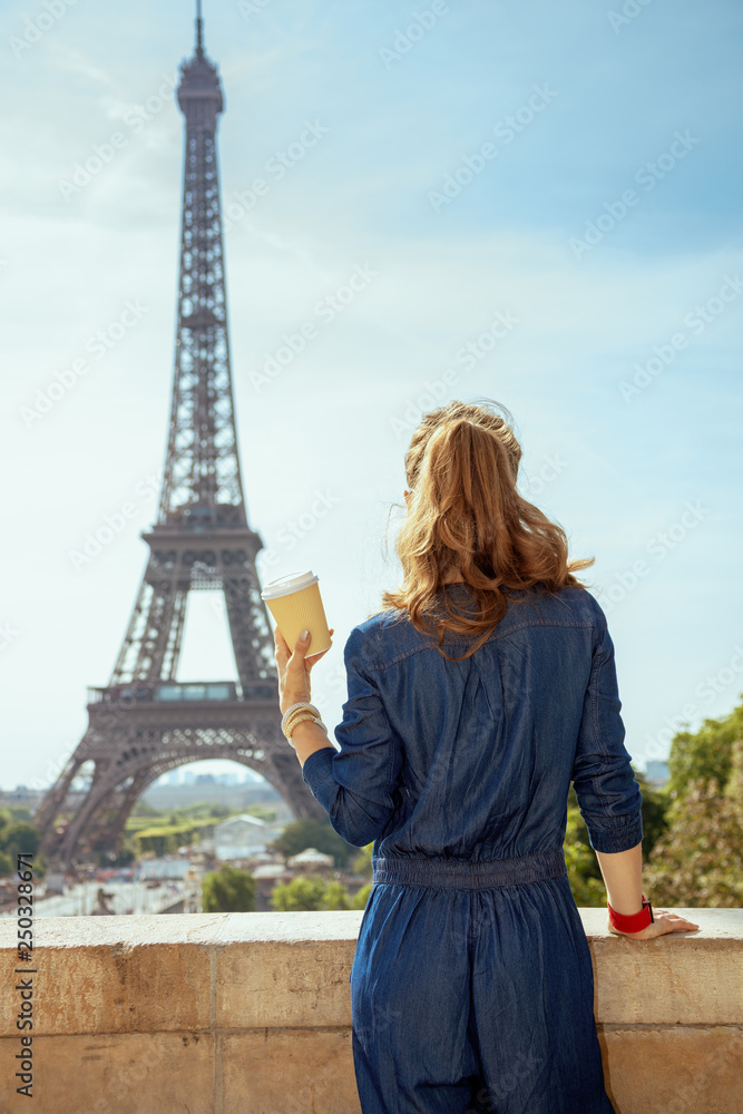 trendy tourist woman with coffee cup in Paris, France