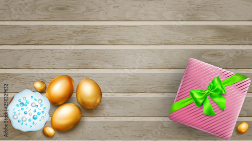 Realistic golden Easter eggs, tasty cake and beautiful gift box with bow on wooden planks