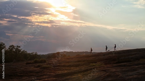 Hiker silhouettes on a mountain.