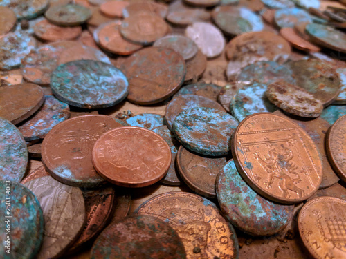 A pile of tarnished and partially corroded British copper coins - one and two pence pieces - and a lot of verdigris