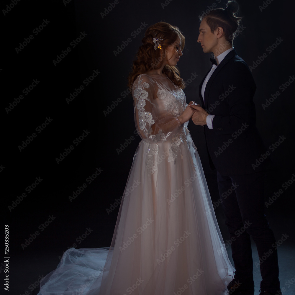 Mysterious and romantic meeting, the bride and groom. Hugs together. Man and woman, wedding dress.