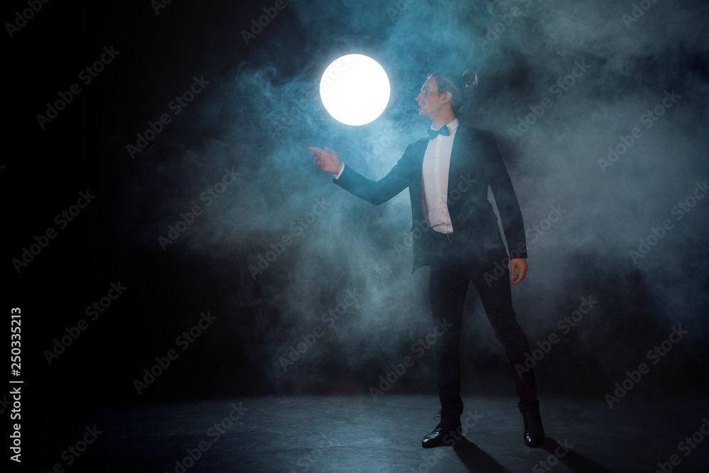 Fototapeta premium lonely Young man in a suit pulls his hand somewhere and waits for someone