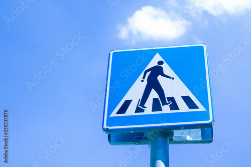 Traffic light on blue sky back ground. A man cross road signal traffic.