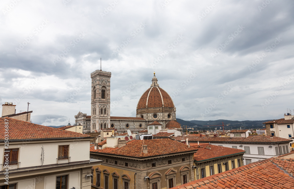 Fototapeta premium View of the Cathedral of Santa Maria - Del - Fiore and the Giotto's bell tower from the rooftops in Florence, Italy