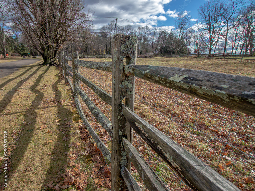 wooden tall fence in new england in autumn