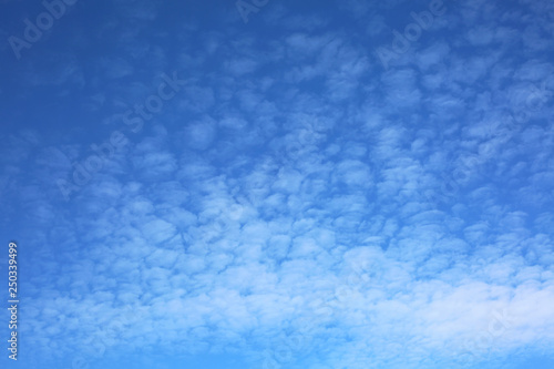 Blue sky background with clouds and copy space.