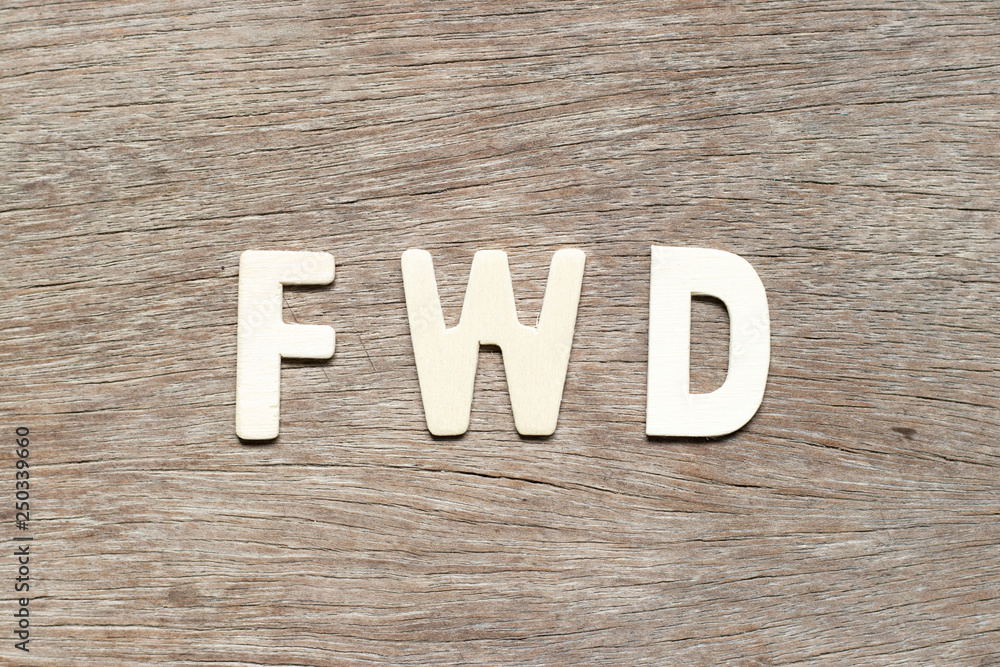 Alphabet letter in word FWD (Abbreviation of forward) on wood background Alphabet letter in word FWD (Abbreviation of forward) on wood background