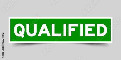 Green color sticker in word qualified on gray background