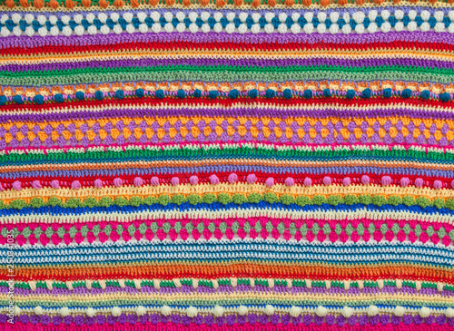 Knitted color background. Knitted texture. A sample of knitting from wool. Knitting Pattern.