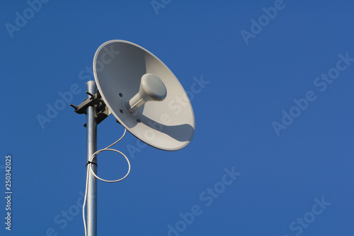 Wireless dish and deep blue sky.