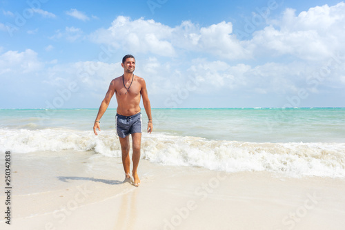 Man walking at the beach © Guajillo studio