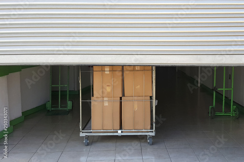 Self storage facility entrance. Trolley cart with boxes photo