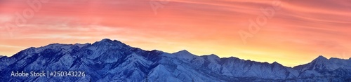 Sunrise of Winter panoramic  view of Snow capped Wasatch Front Rocky Mountains  Great Salt Lake Valley and Cloudscape from the Mountain view Corridor Highway. Utah  USA.