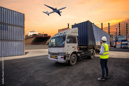 Foreman control loading Containers box to truck for Logistic Import Export Background, Business logistic concept, import and export concept..