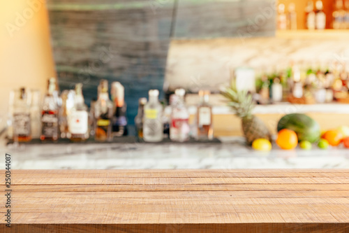 Modern hotel lounge and bar with the shelf of alcoholic drinks. Wooden table top for montage product display.