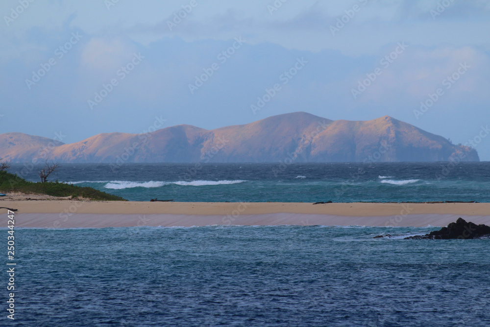 Sandbank in the Sacred Islands with the mountains of the island of Yanuya in the background, Mamanuca Islands, Fiji