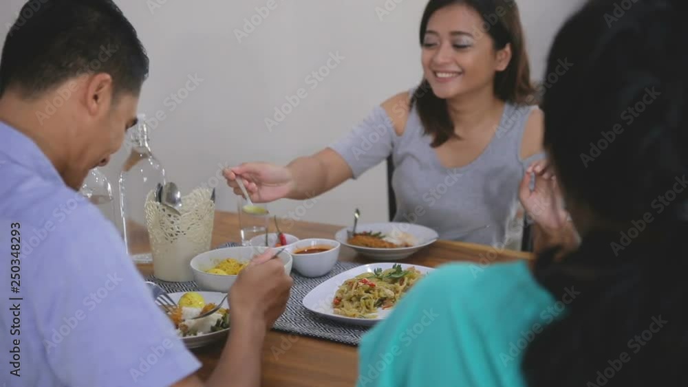 group of young asian people having their lunch in the dining room group of young asian people having their lunch in the dining room