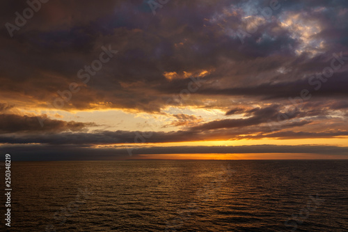 orange sunset in Strait of Georgia near Vancouver Island British Columbia Canada. © olegmayorov