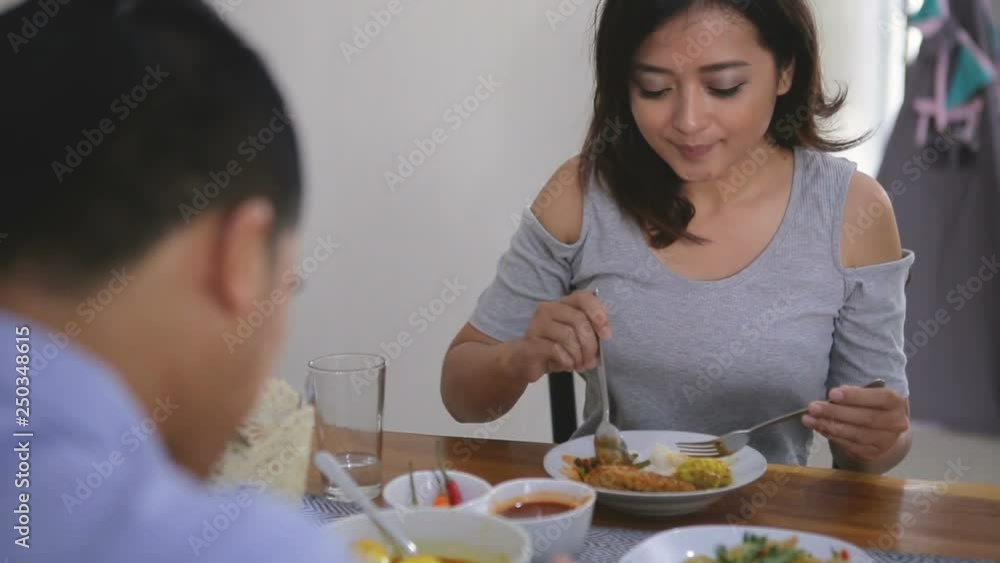 group of young asian people having their lunch in the dining room group of young asian people having their lunch in the dining room