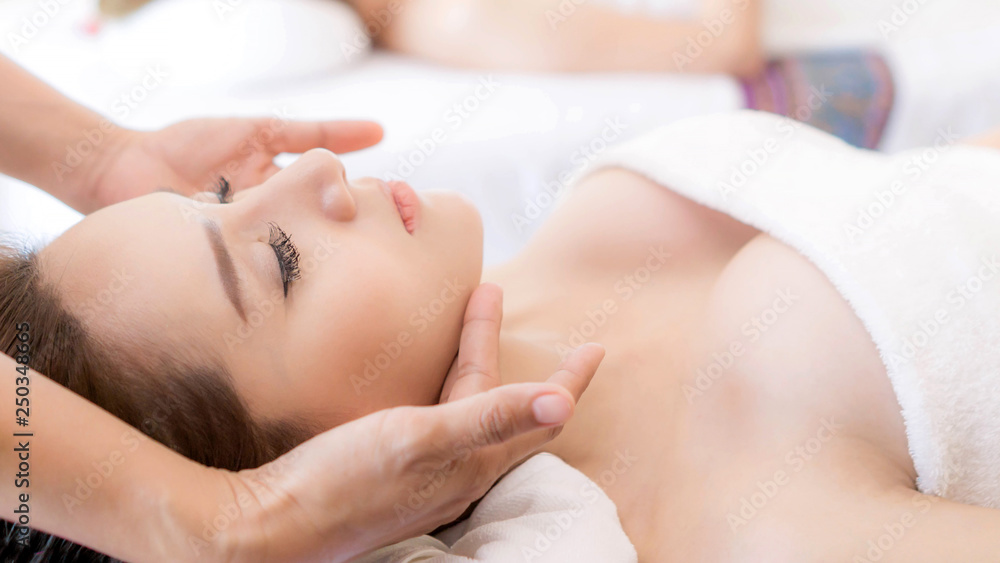 beautiful and healthy young woman relaxing with face massage at beauty spa salon beautiful and healthy young woman relaxing with face massage at beauty spa salon