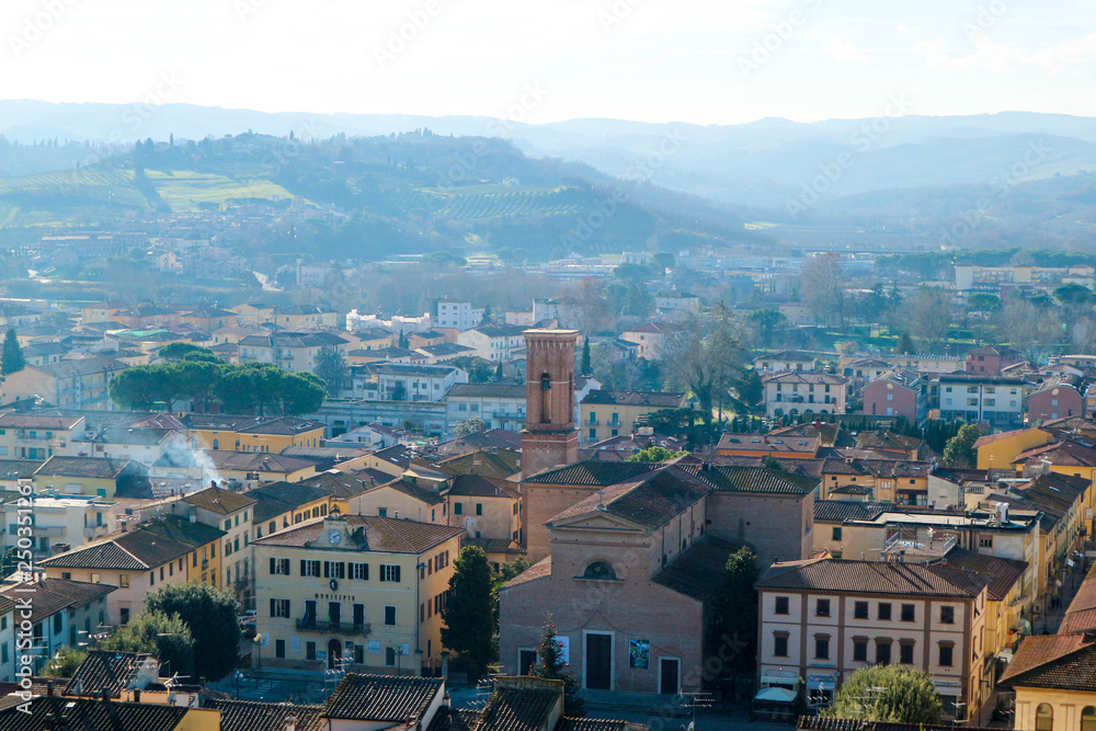  aerial view of the tuscany city Certaldo in morning winter fog with hills on the background, Italy