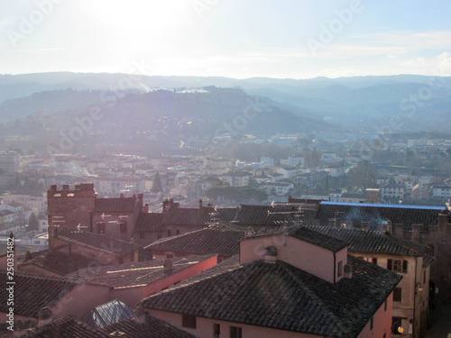 Roofs of little tuscany town Certaldo in morning winter fog, Italy