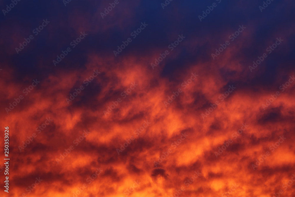 The sky and brightly illuminated clouds at sunset as the background for the design.