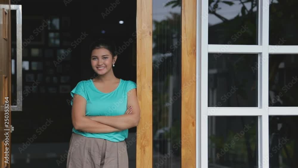 Happy young woman in casual clothes, smiling pose in front of her house Happy young woman in casual clothes, smiling pose in front of her house