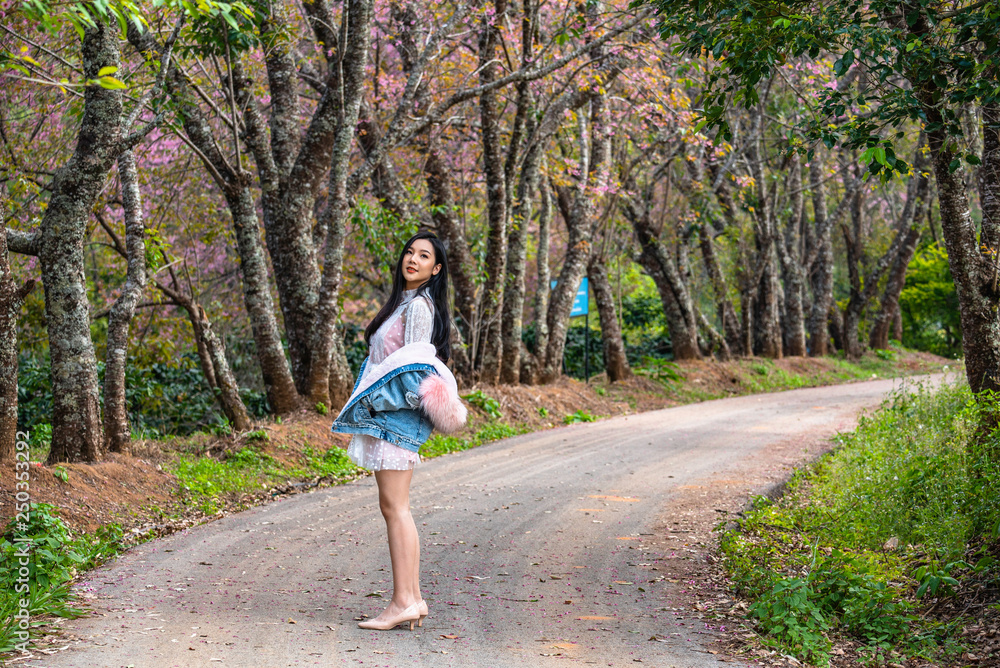 Fototapeta premium Beautiful young teenage girl posing under a trees.