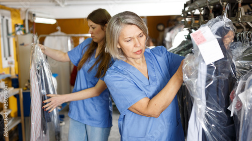 Two female dry-cleaning salon employees