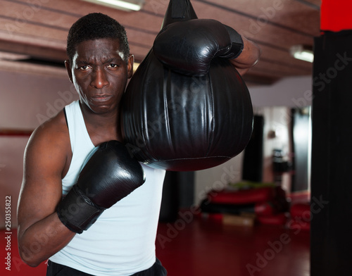 Confident afro american boxer holds training in the ring © JackF
